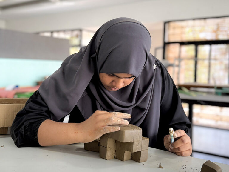 Bachelor of Design students learning clay modelling techniques during a hands-on workshop at CARE School of Design